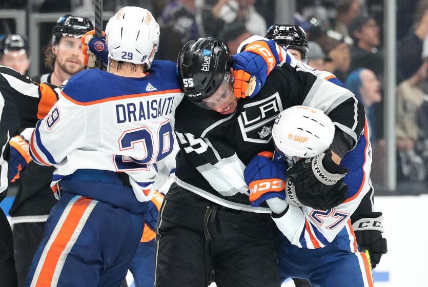 LOS ANGELES, CALIFORNIA - APRIL 26: The Kings Quinton Byfield roughs it up with Oilers Brett Kulak.