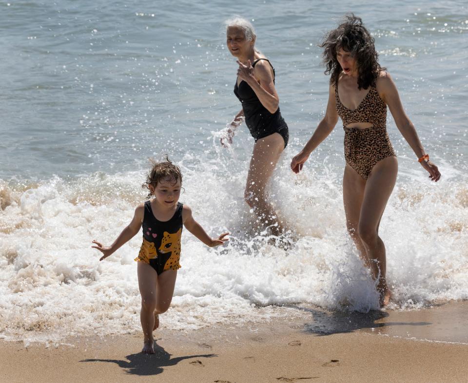 Belmar beachgoers splash in the surf.