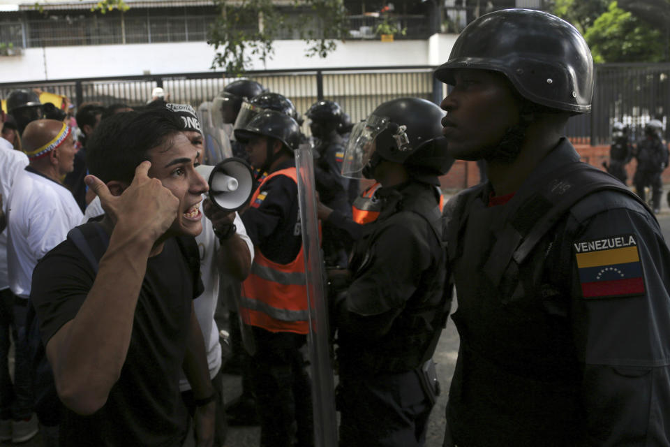 A demonstrator rants at a Venezuelan National Police officer who temporarily blocks members of the opposition from reaching a rally against the government of President Nicolas Maduro in Caracas, Venezuela, Saturday, March 9, 2019.(AP Photo/Fernando Llano)