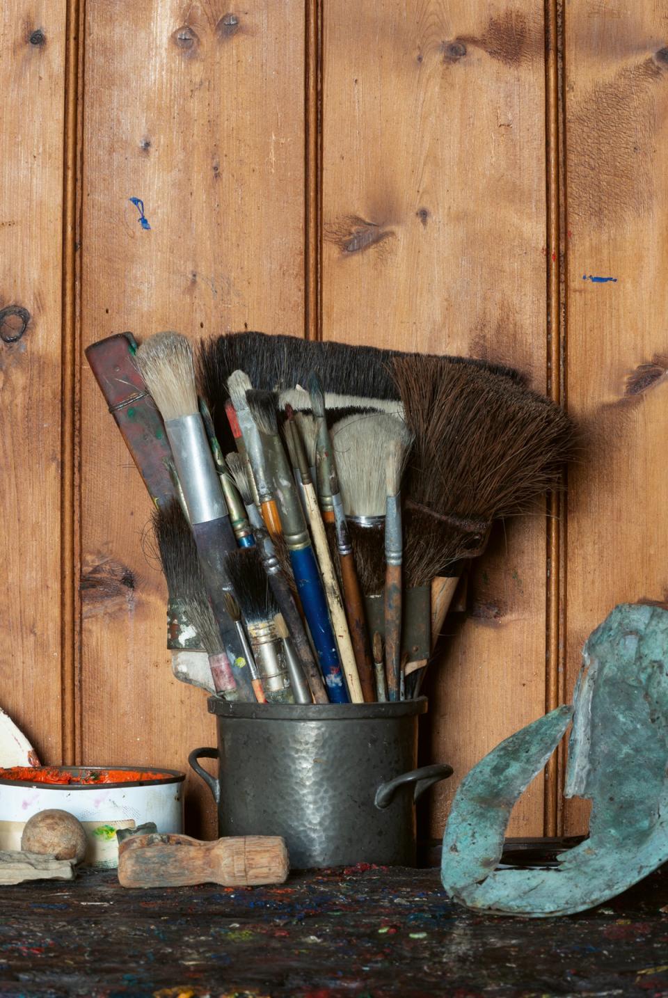 Raw canvases and brushes are stored alongside tubs of grommets and weights used for fishing (Gilbert McCarragher)