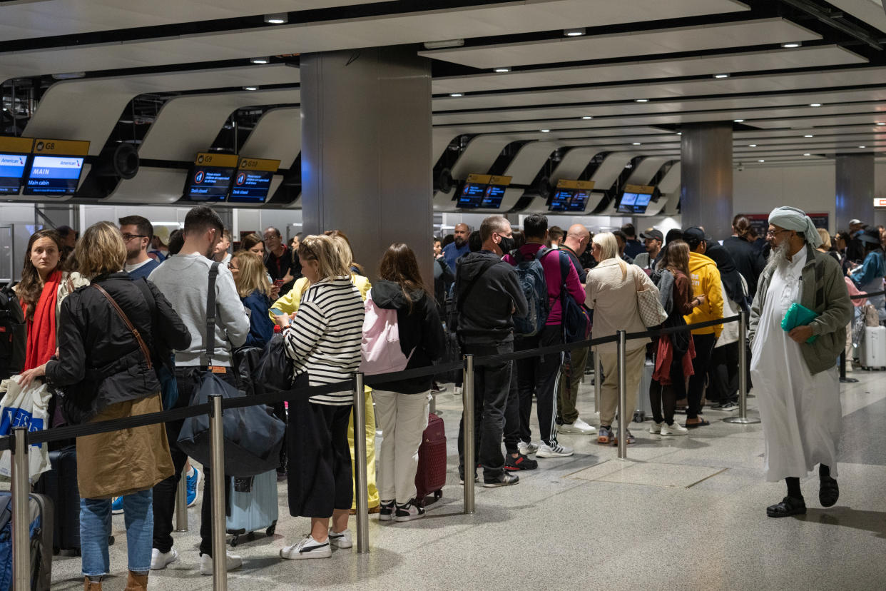 Travellers wait in a long queue to pass through the security check at Heathrow airport. Photo: Carl Court/Getty Images