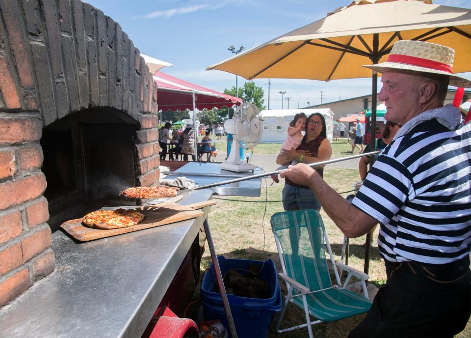 20190609

Vince Larsen with the Tuscan Sun Pizza Company pulls out finished pizzas out of a pizza oven at the annual Festa Italiana at the Lodi Grape Festival grounds in Lodi. i. [CLIFFORD OTO/THE RECORD]