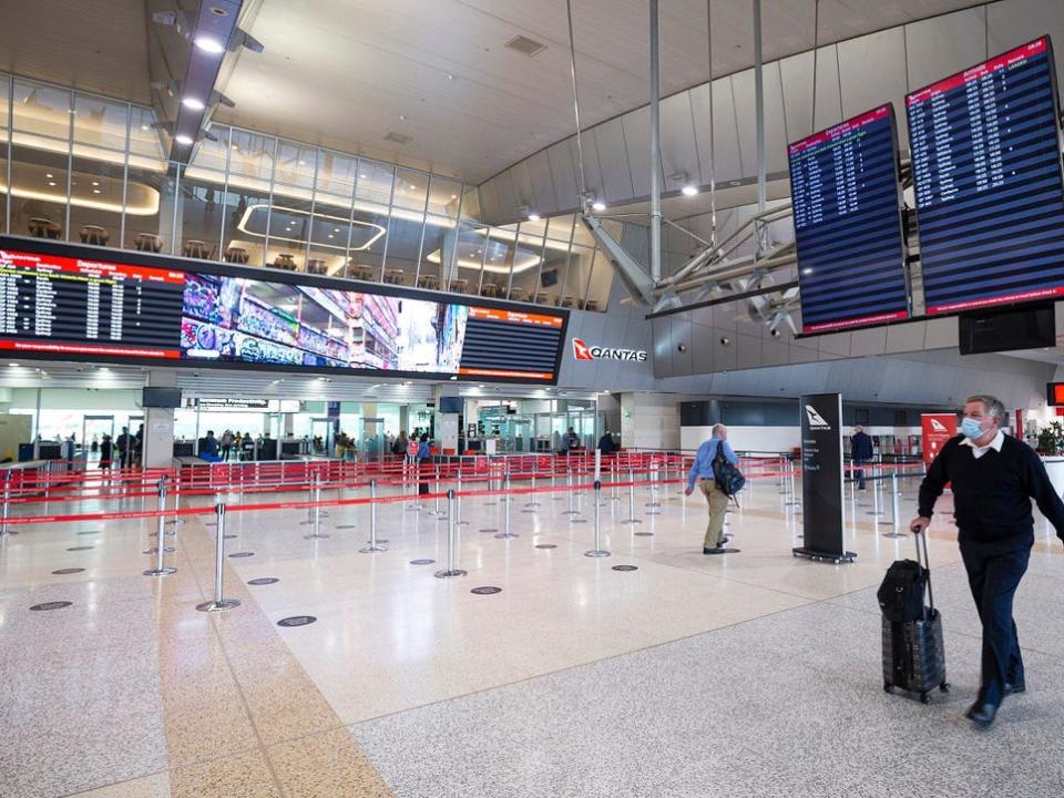 A man walking through the check-in lobby at Melbourne airport.