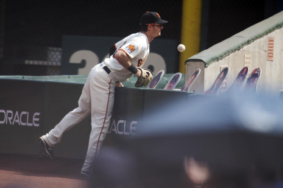 San Francisco Giants right fielder Mike Yastrzemski (5) can't get to a foul ball hit by Seattle Mariners' Dylan Moore during the first inning of a baseball game, Thursday, Sept. 17, 2020 in San Francisco. (AP Photo/D. Ross Cameron)