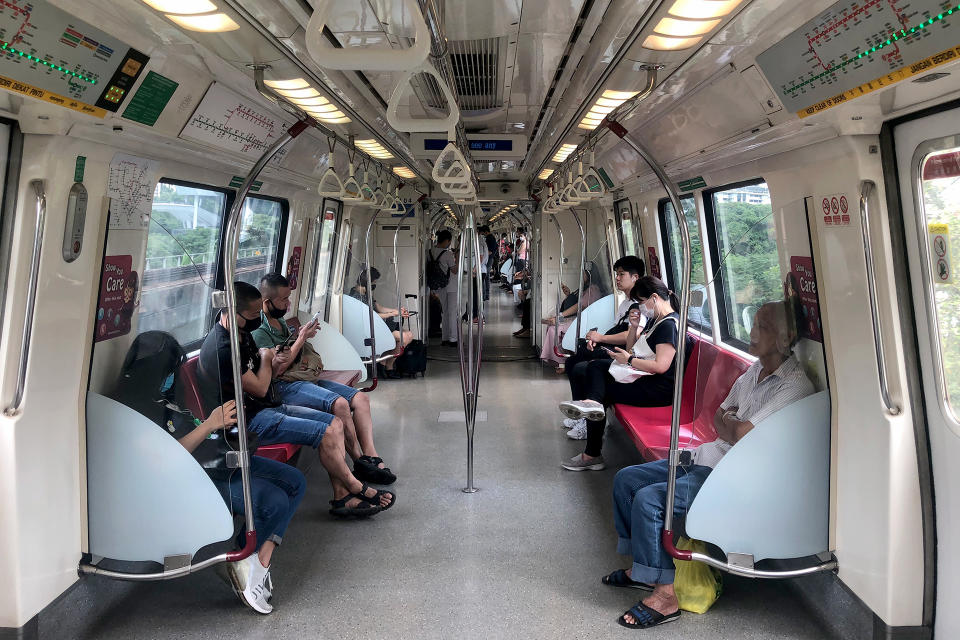People wearing face masks while travelling aboard an East-West Line train on 7 April 2020, the first day of Singapore&amp;#39;s month-long circuit breaker period. (PHOTO: Dhany Osman / Yahoo News Singapore)