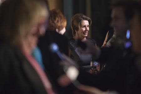 U.S. House Minority Leader Nancy Pelosi (D-CA) talks to reporters as she arrives on the red carpet before the 2013 Mark Twain Prize for American Humor presentation to comedian and actress Carol Burnett at the Kennedy Center in Washington, October 20, 2013. REUTERS/Jonathan Ernst