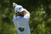 Dustin Johnson watches his tee shot on the 14th hole during practice for the Charles Schwab Challenge golf tournament at the Colonial Country Club in Fort Worth, Texas, Wednesday, June 10, 2020. (AP Photo/David J. Phillip)