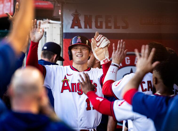 Anaheim, CA - July 21: Angels starting pitcher and two-way player Shohei Ohtani is congratulated.