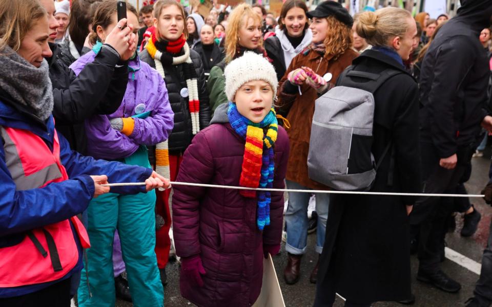 Swedish climate activist Greta Thunberg, centre, marches with others during a climate change protest in Brussels.  - AP