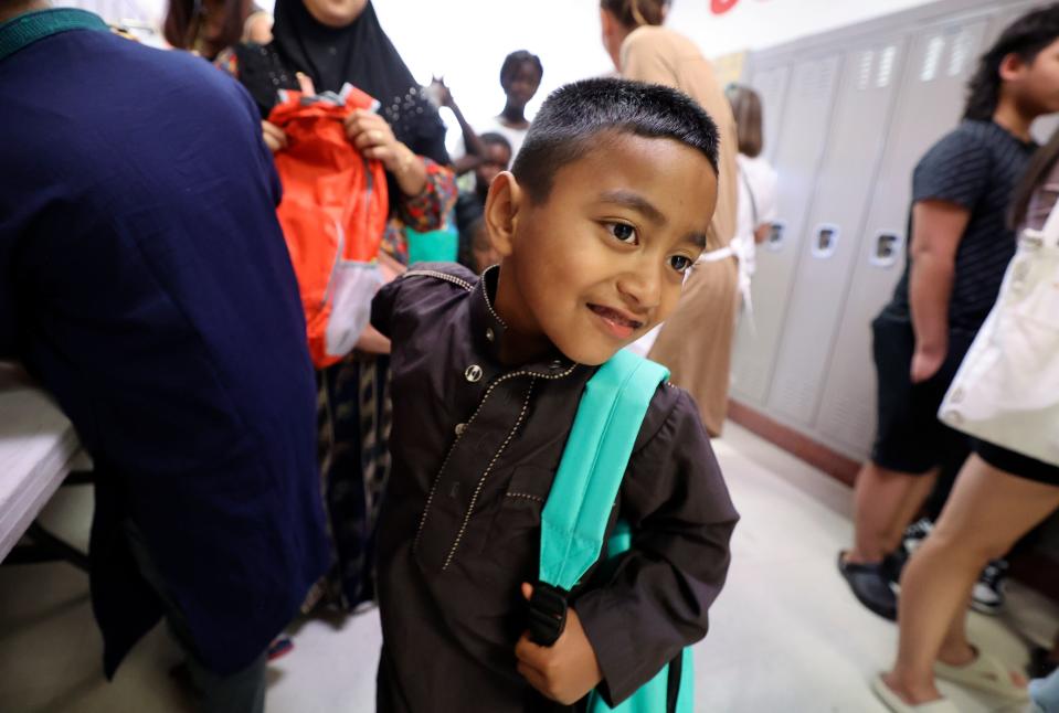 Arfan Mothkor tries on his new backpack during Refugee Back to School Night at Granite Park Junior High in South Salt Lake on Monday, Aug. 7, 2023. | Kristin Murphy, Deseret News