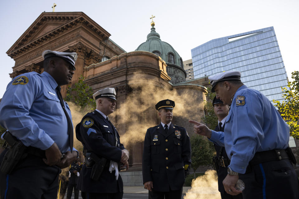 Law enforcement officers gather for a viewing for officer Richard Mendez at the Cathedral Basilica of Saints Peter and Paul in Philadelphia, Tuesday, Oct. 24, 2023. Mendez was shot and killed, and a second officer was wounded when they confronted people breaking into a car at Philadelphia International Airport, Oct. 12, police said. (AP Photo/Joe Lamberti)