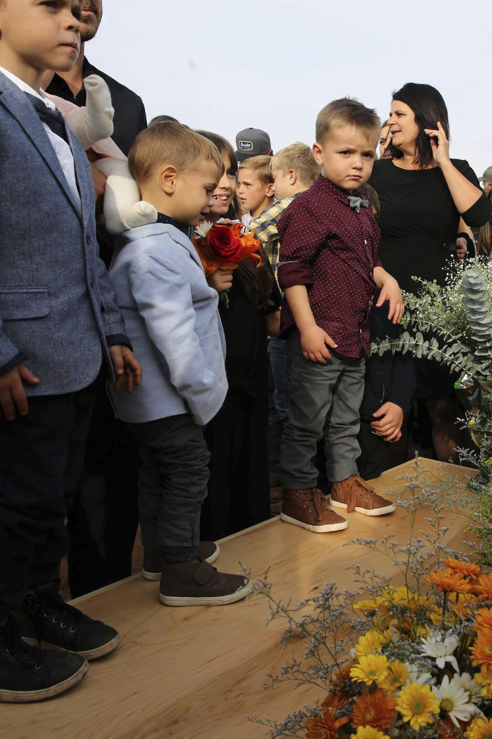 Family and friends attend the burial service for Christina Langford Johnson the last victim of a cartel ambush that killed nine American women and children earlier this week, in Colonia Le Baron, Mexico, Saturday, Nov. 9, 2019. In the attack Monday, Langford Johnson jumped out of her vehicle and waved her hands to show she was no threat to the attackers and was shot twice in the heart, community members say. Her daughter Faith Marie Johnson, 7 months old, was found unharmed in her car seat. (AP Photo/Marco Ugarte)