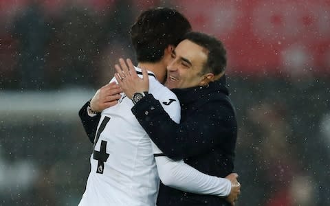 Swansea City manager Carlos Carvalhal and Ki Sung Yueng celebrate after the match - Credit: Action Images