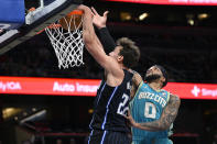 Orlando Magic forward Franz Wagner, left, dunks as Charlotte Hornets forward Miles Bridges (0) defends during the first half of an NBA basketball game, Tuesday, March 19, 2024, in Orlando, Fla. (AP Photo/Phelan M. Ebenhack)