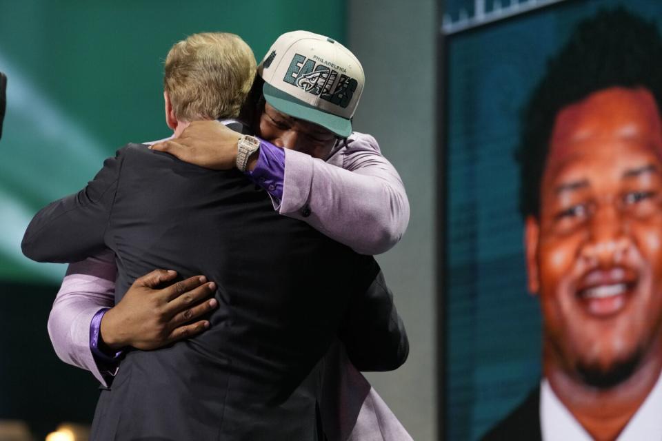 Jalen Carter of the Philadelphia Eagles bear-hugs NFL commissioner Roger Goodell