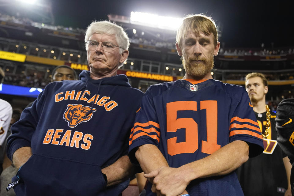 Chicago Bears fans during a moment of silence before the start of an NFL football game between the Washington Commanders and the Chicago Bears, Thursday, Oct. 5, 2023, in Landover, Md. Butkus, the fearsome middle linebacker for the Bears, has died, the team announced Thursday. (AP Photo/Andrew Harnik)