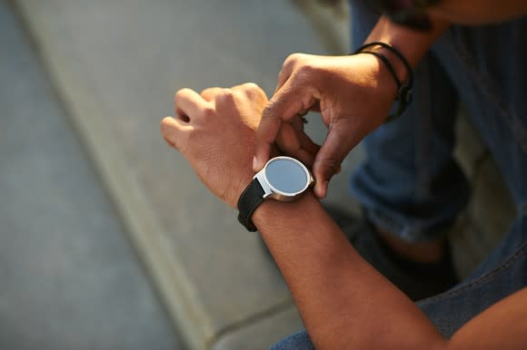 A man interacts with his fitness tracker.