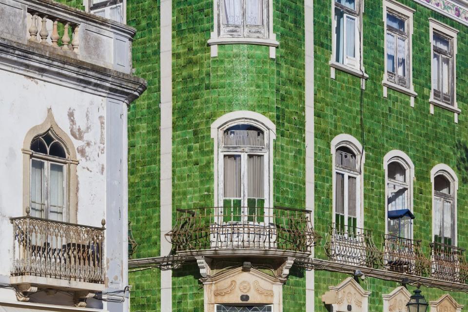 <p>A grass-green tiled facade creates a texturally rich dream home. </p>