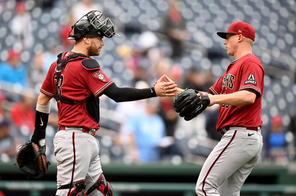 Scott McGough #30 of the Arizona Diamondbacks celebrates with Carson Kelly #18 after a 5-3 victory against the Washington Nationals at Nationals Park on June 22, 2023, in Washington, DC.