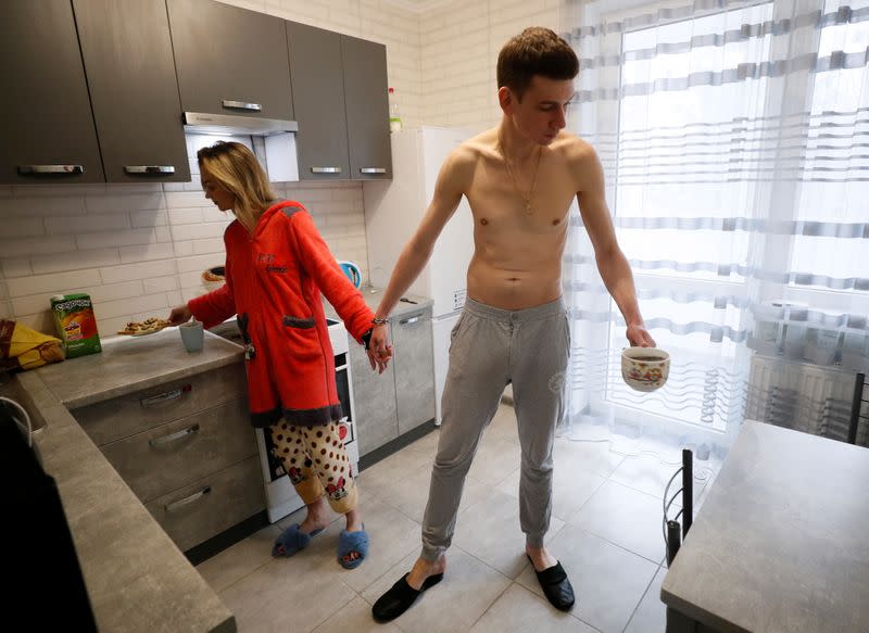 Alexandr Kudlay and Viktoria Pustovitova make breakfast in their apartment in Kharkiv