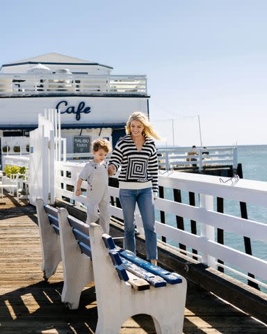 <p>Jessica Sample/Travel + Leisure</p> Elvis Cordero wears Zara shirt and overalls; Amanda Kloots wears Staud sweater and Zara tank