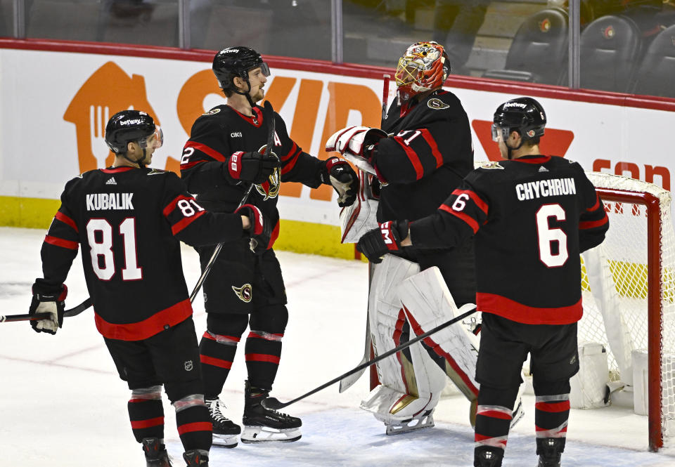 Ottawa Senators' Thomas Chabot (72) celebrates his team's win over the Buffalo Sabres with goaltender Anton Forsberg (31), Dominik Kubalik (81) and Jakob Chychrun (6) following NHL hockey game action in Ottawa, Ontario, Sunday, Dec. 31, 2023. (Justin Tang/The Canadian Press via AP)