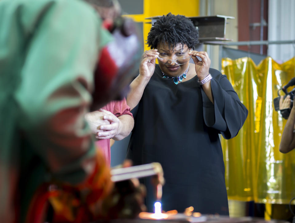 Georgia Democratic gubernatorial candidate Stacey Abrams watches a student cut metal with a torch during a campaign stop at the Ironworkers Local 709 apprenticeship shop to announce her "Jobs for Georgia Plan", Thursday, July 26, 2018, in Pooler, Ga. (AP Photo/Stephen B. Morton)