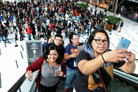 FILE PHOTO: A customer takes as selfie as she waits in the queue for the opening of the first Apple Store in Mexico City, Mexico September 24, 2016. REUTERS/Ginnette Riquelme/File Photo