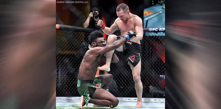 Petr Yan knees Aljamain Sterling at UFC 259