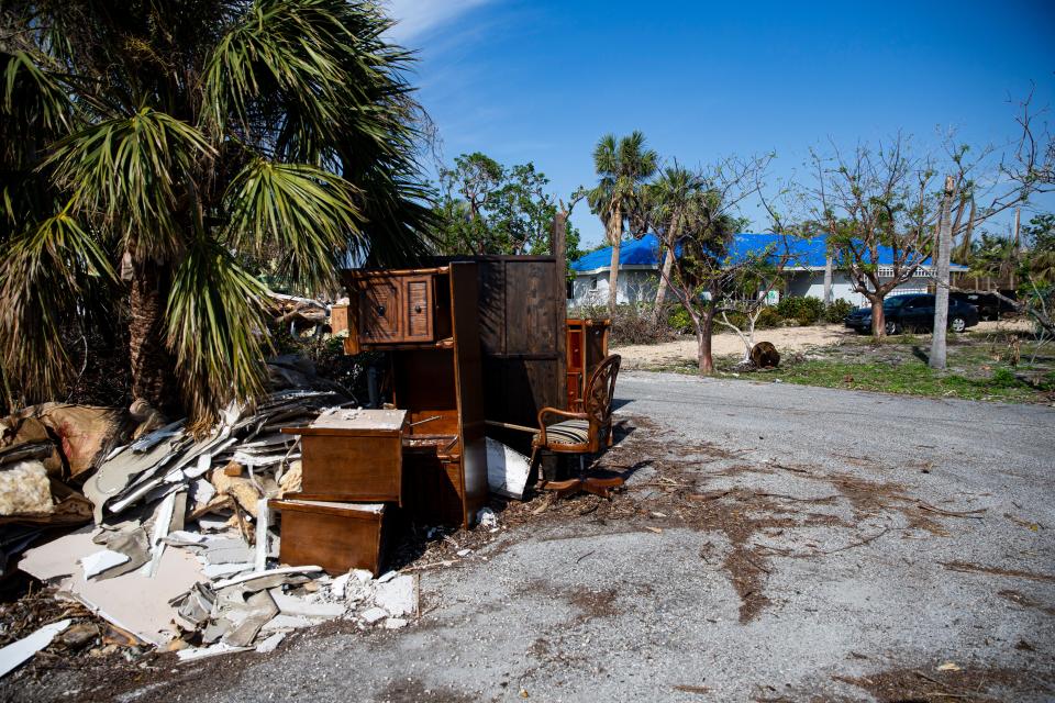 Debris is seen piled up in a neighborhood on Sanibel Island on Wednesday, Jan. 4, 2023. 