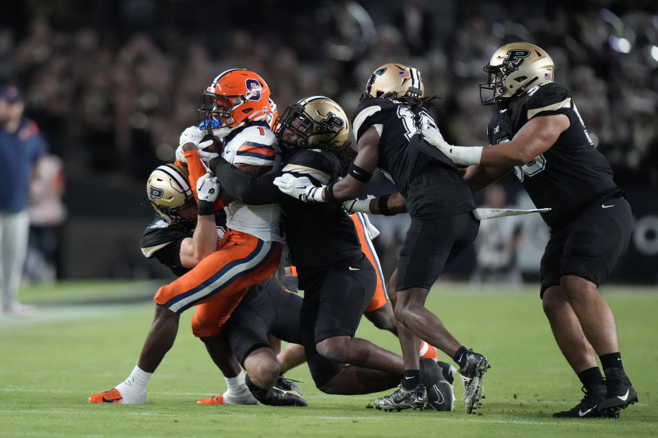 Syracuse running back LeQuint Allen Jr. (1) is tackled by Purdue defenders during the first half of an NCAA college football game in West Lafayette, Ind., Saturday, Sept. 16, 2023.(AP Photo/AJ Mast)