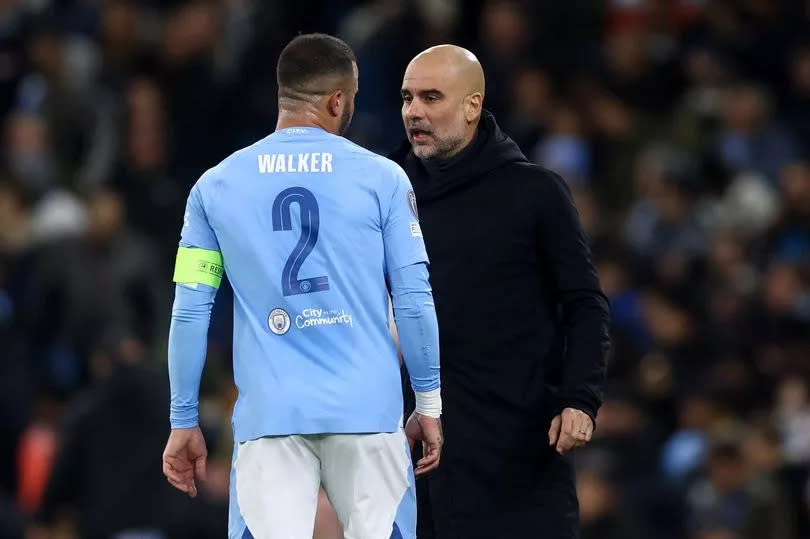 Pep Guardiola and Kyle Walker in conversation during a Champions League game