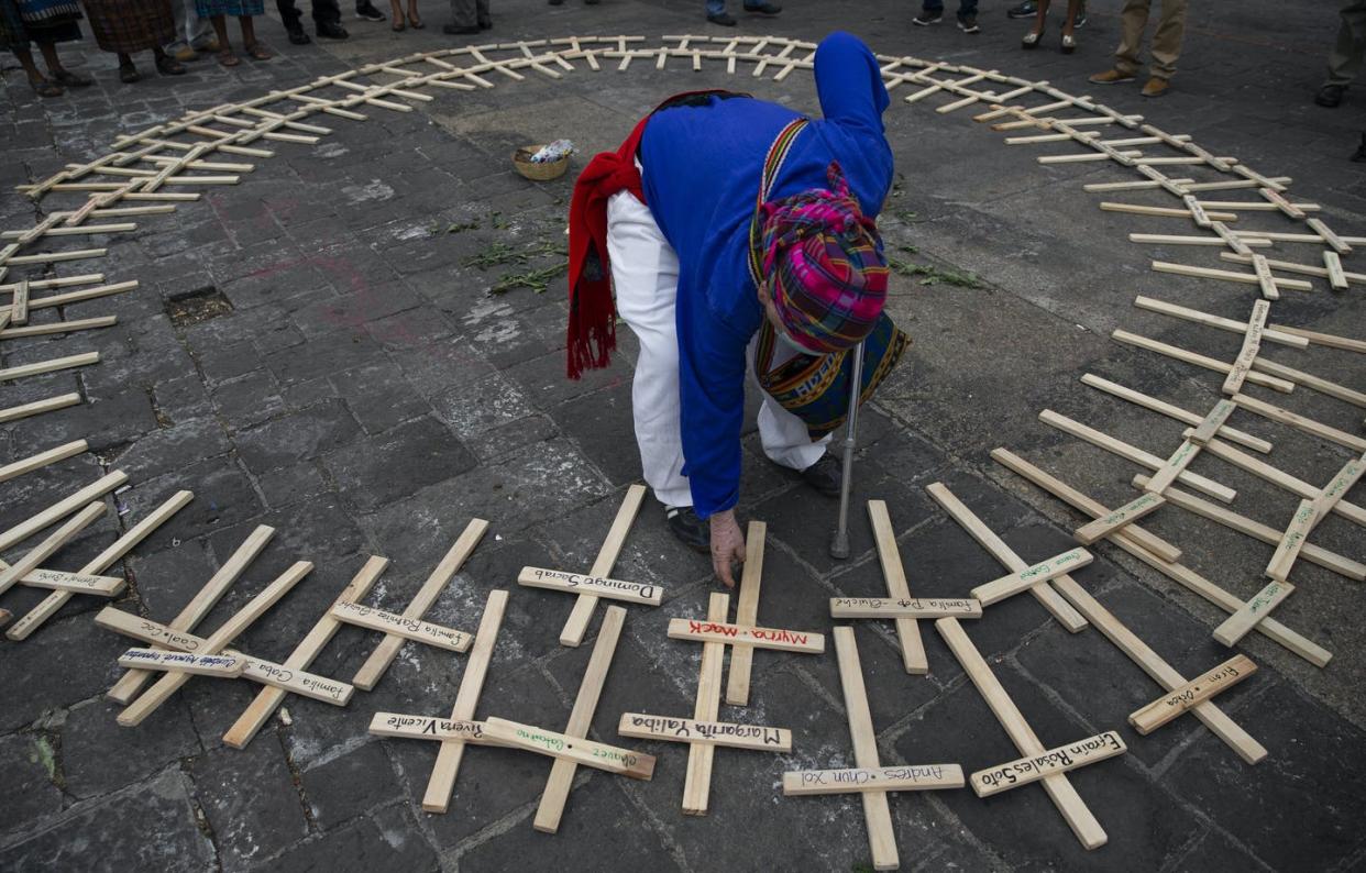 <span class="caption">A Mayan spiritual guide arranges crosses, marked with the names of people who died in the nation's civil war, in a circle in preparation for a ceremony marking the National Day of Dignity for the Victims of Armed Internal Conflict. Guatemalans annually honor the victims of the 36-year civil war that ended in 1996 on Feb. 25. </span> <span class="attribution"><span class="source">(AP Photo/Moises Castillo) </span></span>