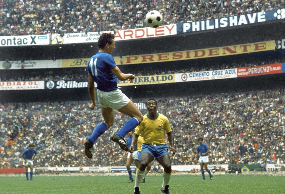 FILE - Italian forward Gigi Riva, heads the ball as Brazilian star Pele looks on during the World Cup final match at Azteca Stadium, Mexico City, Mexico, June 21, 1970. Italy’s all-time leading goalscorer Luigi Riva has died. He was 79. The Italian soccer federation has confirmed the news and tributes have started flooding in for Riva. Riva remains Italy’s leading goalscorer, having netted 35 times in 42 appearances. As a player, he helped the Azzurri win the European Championship in 1968 and finish runners-up at the World Cup, two years later.He was also team manager of the national team from 1990-2013 and was instrumental in Italy winning its fourth World Cup in 2006. (AP Photo/Carlo Fumagalli)