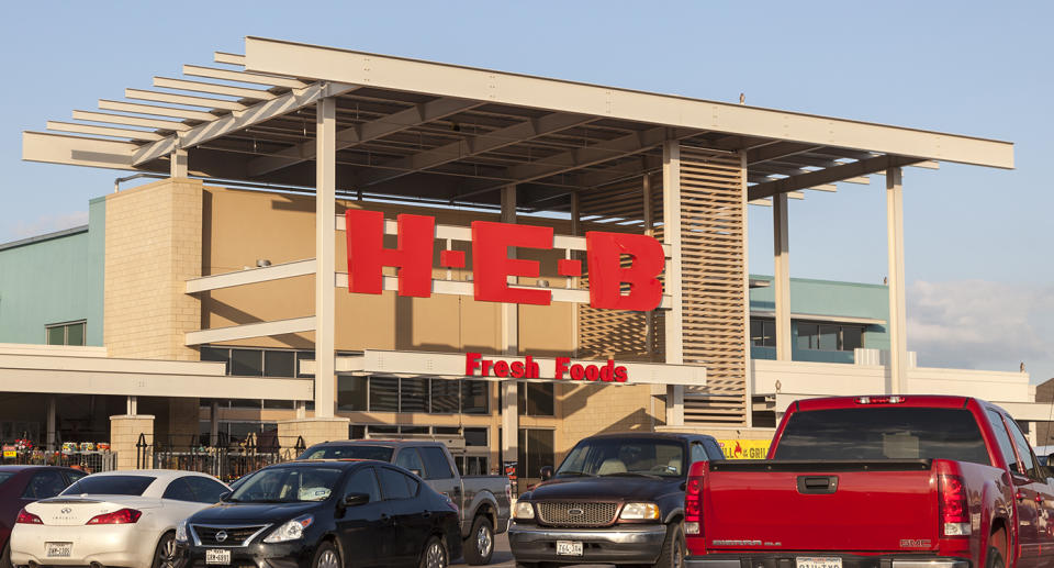 An image of an H.E.B store with cars parked out the front.