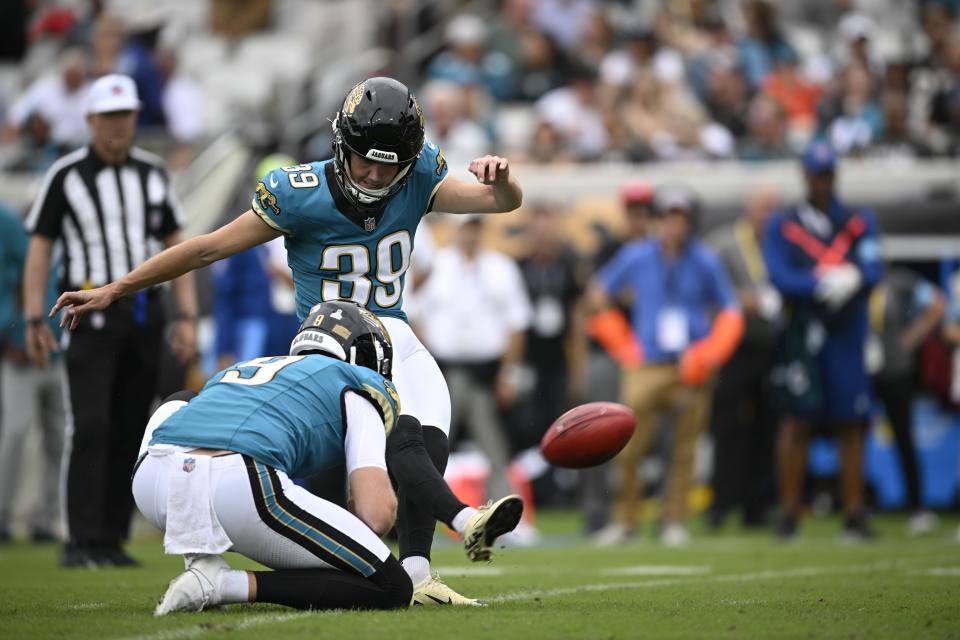 Jacksonville Jaguars place kicker Cam Little (39) kicks a field goal out of the hole of Logan Cooke during the first half of an NFL football game against the Indianapolis Colts, Sunday, Oct. 6, 2024, in Jacksonville, Fla. (AP Photo/Phelan M. Ebenhack)