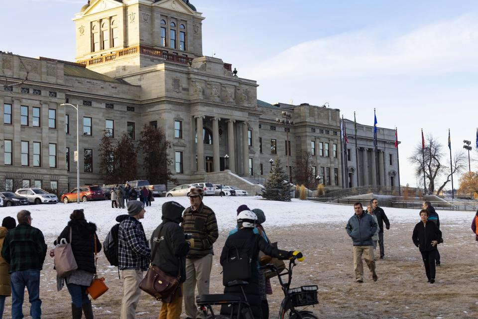 Staff evacuate from the Montana State Capitol, Wednesday morning, Jan. 3, 2023, after a bomb threat. (Thom Bridge/Independent Record via AP)