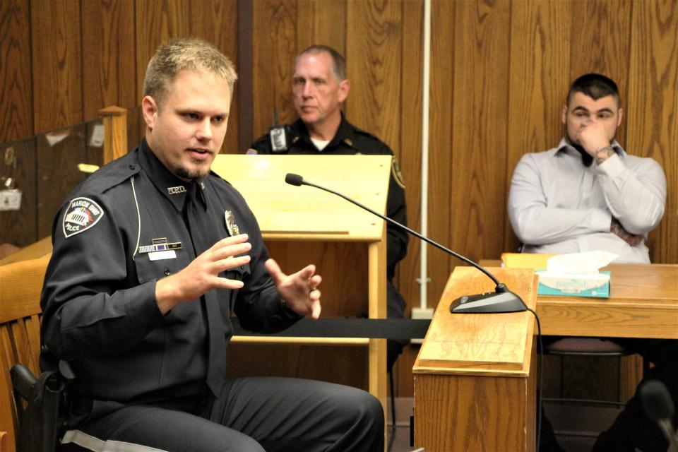 Marion Police Officer Caleb Rector, left, testifies on Wednesday, July 26, 2023, during the trial of Teddy G. Thomas III, right. Thomas was accused of trying to kill Rector with a machete during a domestic violence incident on Feb. 12, 2023.