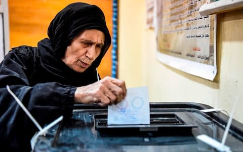 An elderly Egyptian woman casts her ballot in a box - Credit: KHALED DESOUKI/AFP/Getty Images