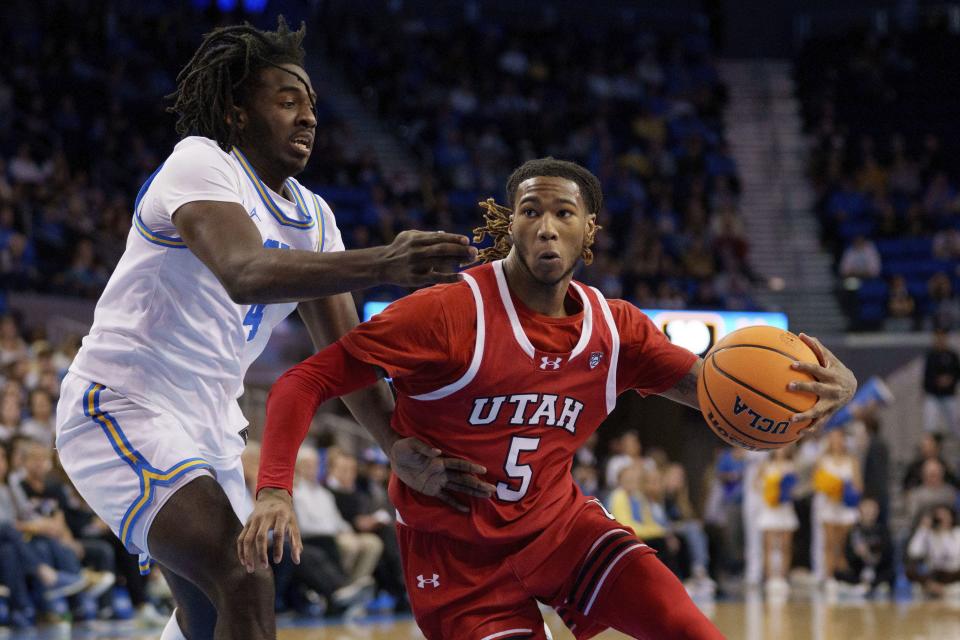 Utah guard Deivon Smith (5) drives against UCLA guard Will McClendon (4) during the first half of an NCAA college basketball game, Sunday, Feb. 18, 2024, in Los Angeles. | Eric Thayer, AP