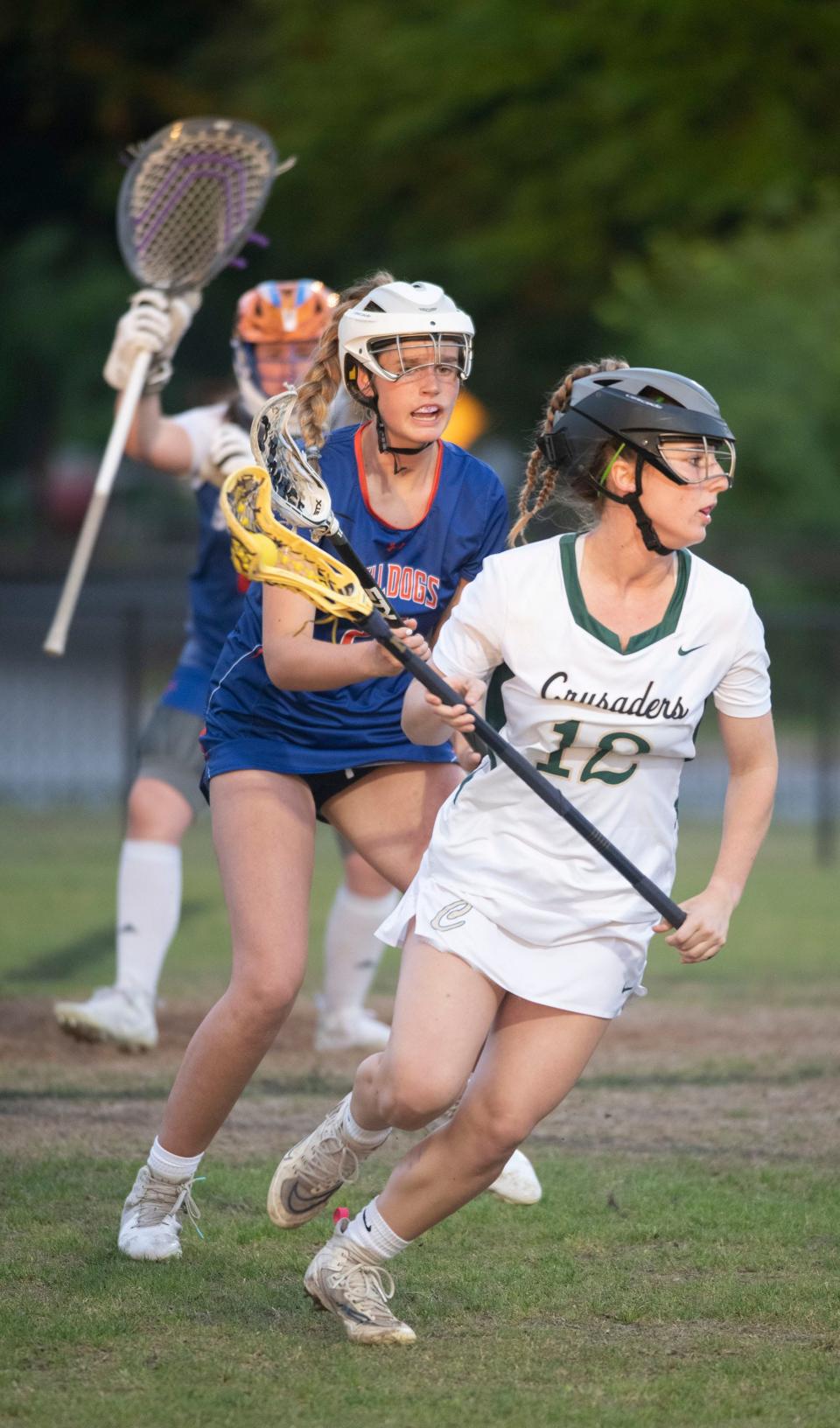 Catholic's Julia Frosch (No. 12) looks for an open teammate as Bolles'  Olivia Janse Van Rensburg (No. 2) put up a defense during Friday's District 1-A girls' lacrosse semi-finals match. 