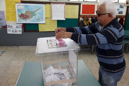 A Turkish Cypriot man casts his vote at a polling station in Famagusta, nothern Cyprus, April 19, 2015. REUTERS/Yiannis Kourtoglou