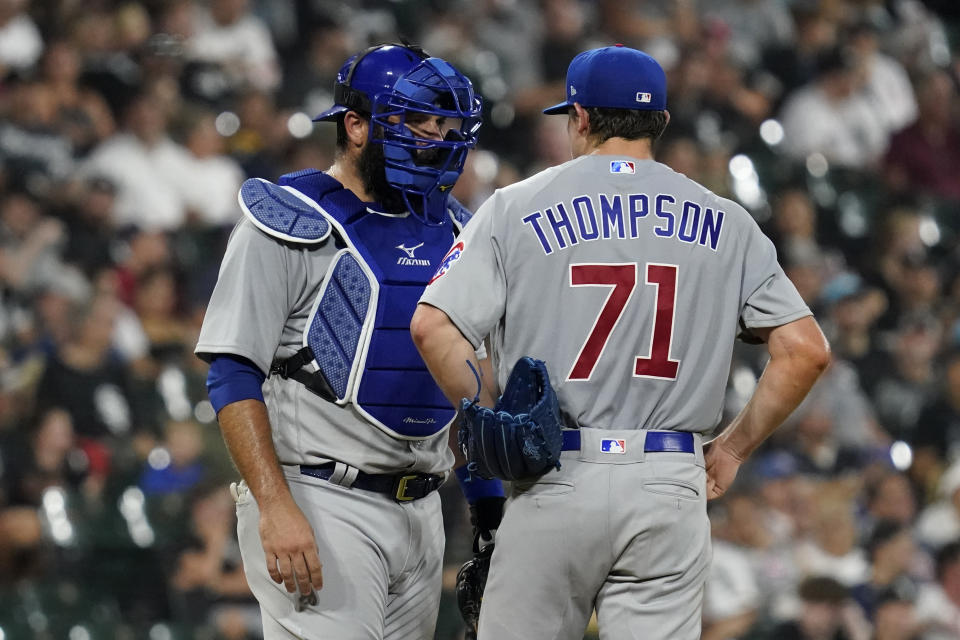 Chicago Cubs catcher Austin Romine, left, talks with starting pitcher Keegan Thompson during the first inning of the team's baseball game against the Chicago White Sox in Chicago, Friday, Aug. 27, 2021. (AP Photo/Nam Y. Huh)