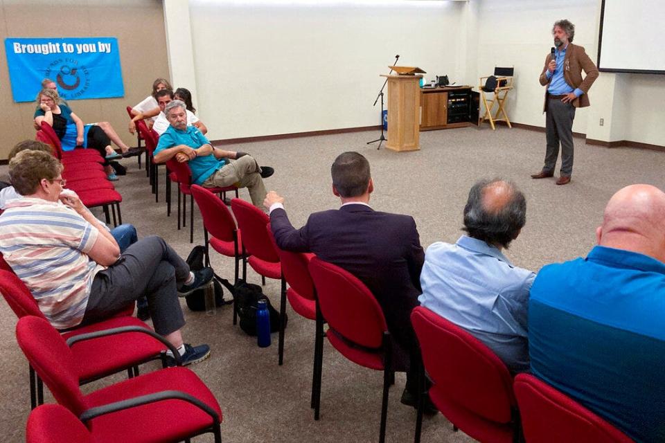 David Clements, a New Mexico-based former prosecutor and former college professor, speaks to an audience at a public library auditorium in Albuquerque, N.M., Sept. 3, 2022. At conventions, church gatherings and local forums, Clements advocates for eliminating electronic election equipment and exonerating many of the defendants charged in the violent Jan. 6, 2021, attack on the U.S. Capitol.