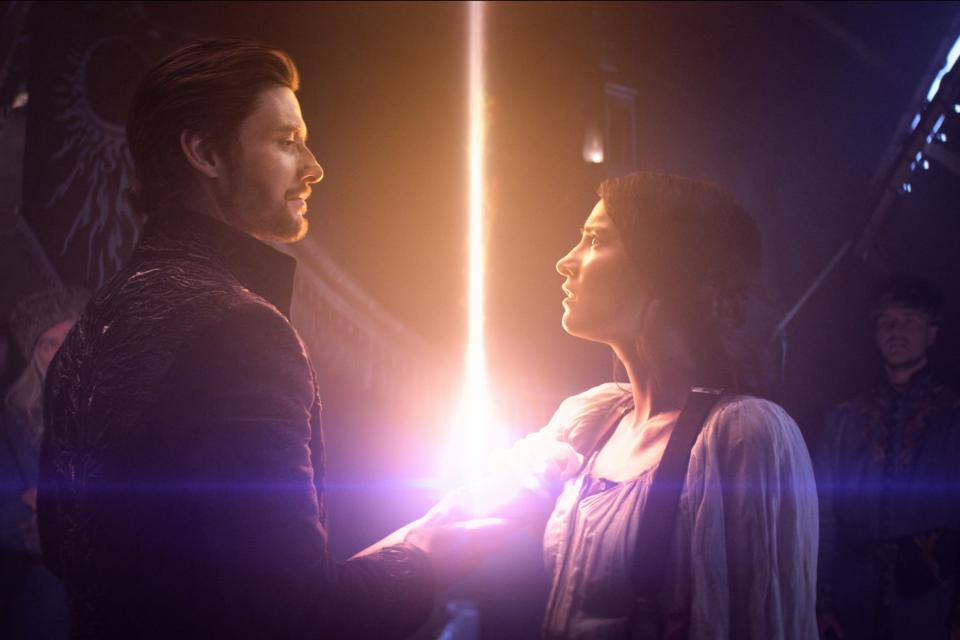 Still from "Shadow and Bone" featuring Ben Barnes (L) and Jessie Mei Li (R). A beam of light escapes from the latter's arm as the former holds it