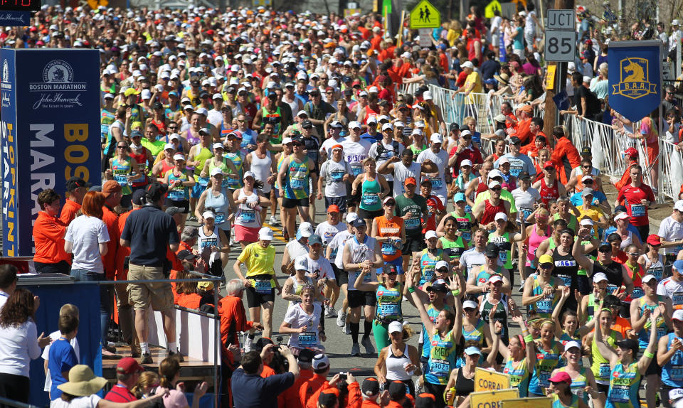 Runners make their way across the start line of the 116th running of the Boston Marathon, in Hopkinton, Mass., Monday, April 16, 2012. (AP Photo/Stew Milne)