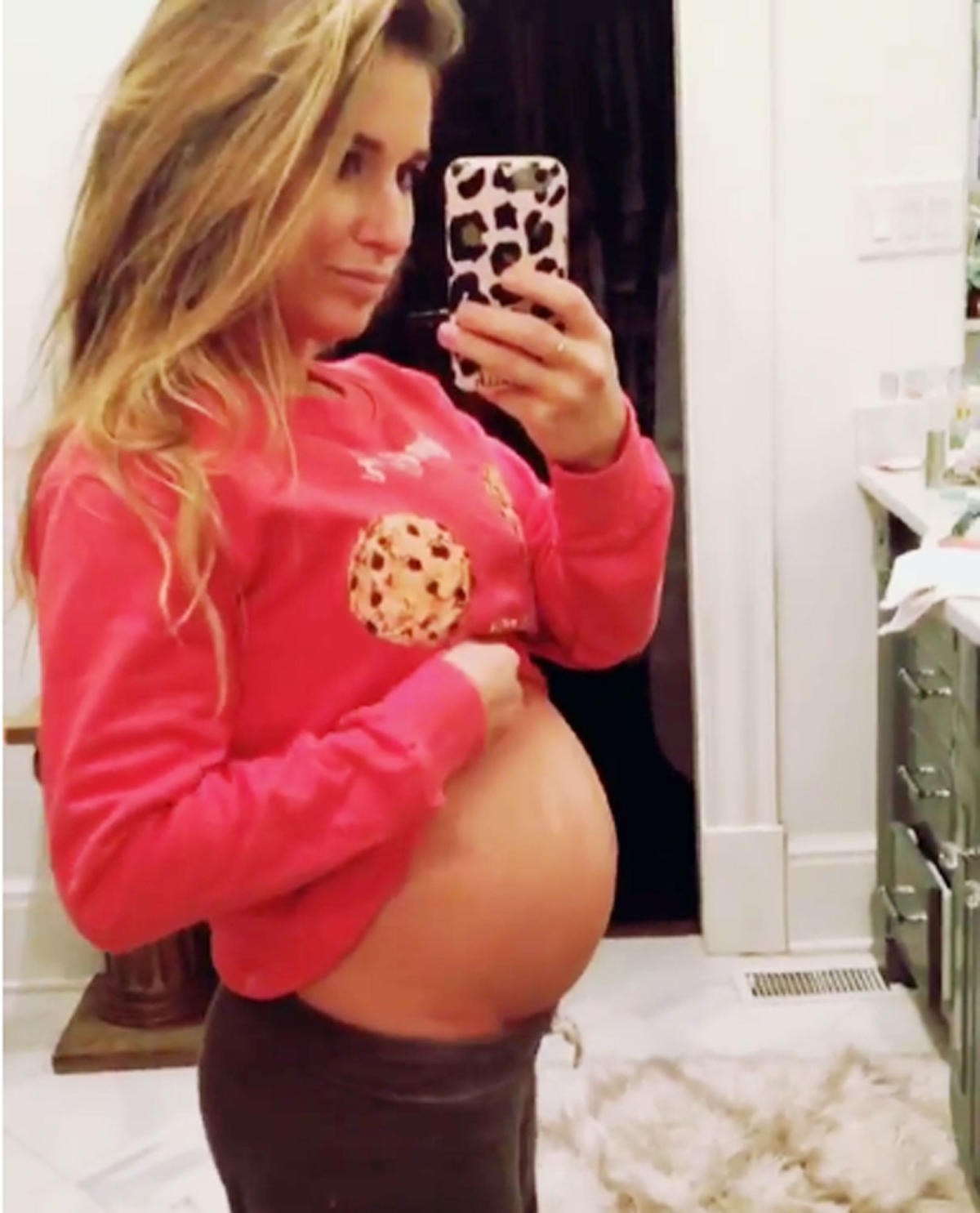 Pregnant Jessie James Decker cradles baby bump and gets a steamy