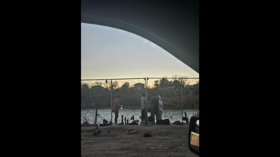 Young migrants attempt to break through the wire fencing at the border in Eagle Pass, Texas