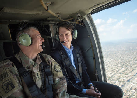 Jared Kushner (R), Senior Advisor to President Donald J. Trump, is pictured during a helicopter transit over Baghdad, Iraq, in this April 3, 2017 handout photo. Navy Petty Officer 2nd Class Dominique A. Pineiro/DoD/Handout via REUTERS