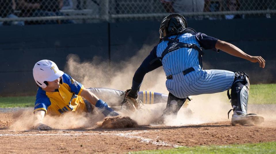 Turlock’s Carter Crivelli is tagged out at the plate by Downey catcher Andre Mendoza during the Central California Athletic League game at Downey High School in Modesto, Calif., Friday, April 12, 2024. Turlock won the game 3-2.